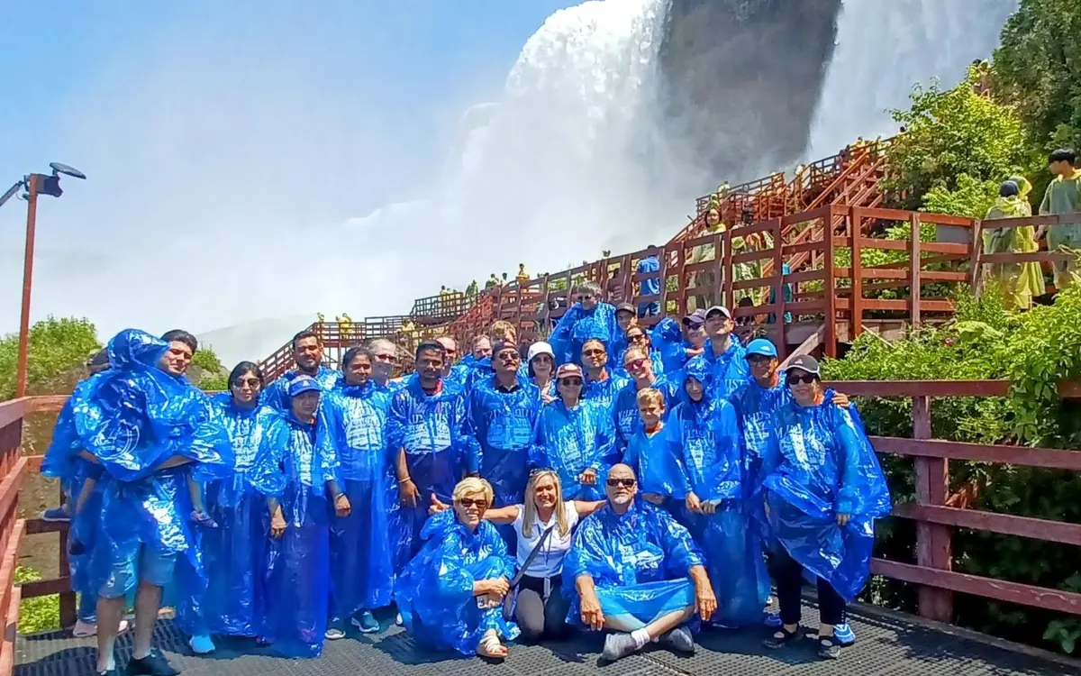 Passengers in blue ponchos on the deck of the Maid of the Mist